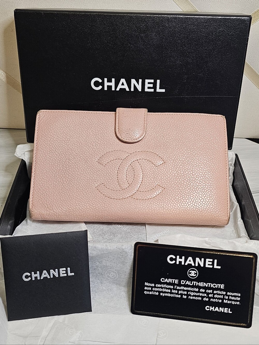 CHANEL Timeless CC Flap Wallet crafted in pink Caviar textured leather.